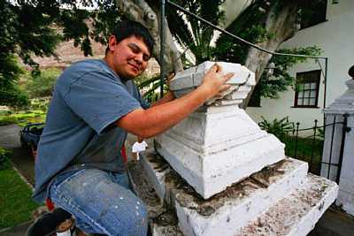 Clint Fowler fitting together the broken parts of the gatepost top